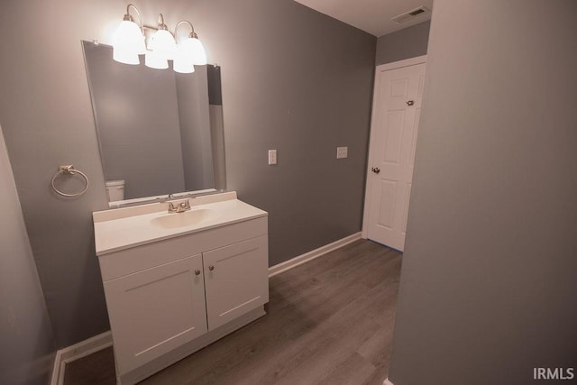 1034 Harter Blvd, Anderson, IN 46011 - bathroom with vanity, wood finished floors, baseboards, and a chandelier
