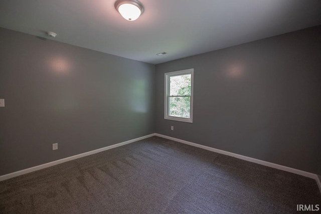 1034 Harter Blvd, Anderson, IN 46011 - unfurnished room with baseboards and dark colored carpet