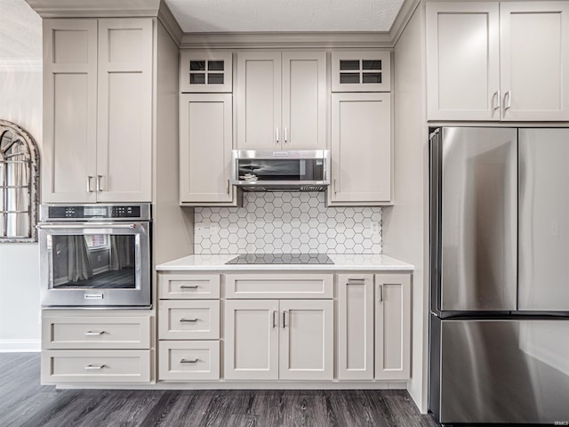 2747 Thornhill Dr, Evansville, IN 47725 - kitchen featuring stainless steel appliances, light countertops, dark wood-style flooring, and decorative backsplash