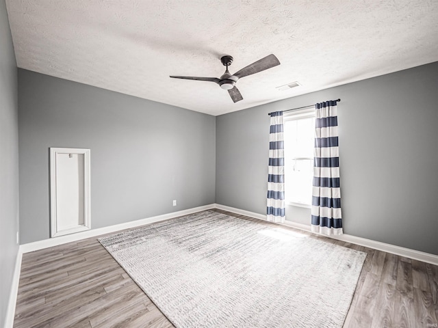 2747 Thornhill Dr, Evansville, IN 47725 - unfurnished room featuring a ceiling fan, wood finished floors, a textured ceiling, and baseboards