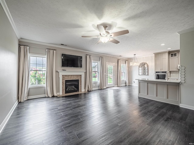 2747 Thornhill Dr, Evansville, IN 47725 - unfurnished living room with a textured ceiling, ceiling fan, a fireplace, baseboards, and dark wood finished floors