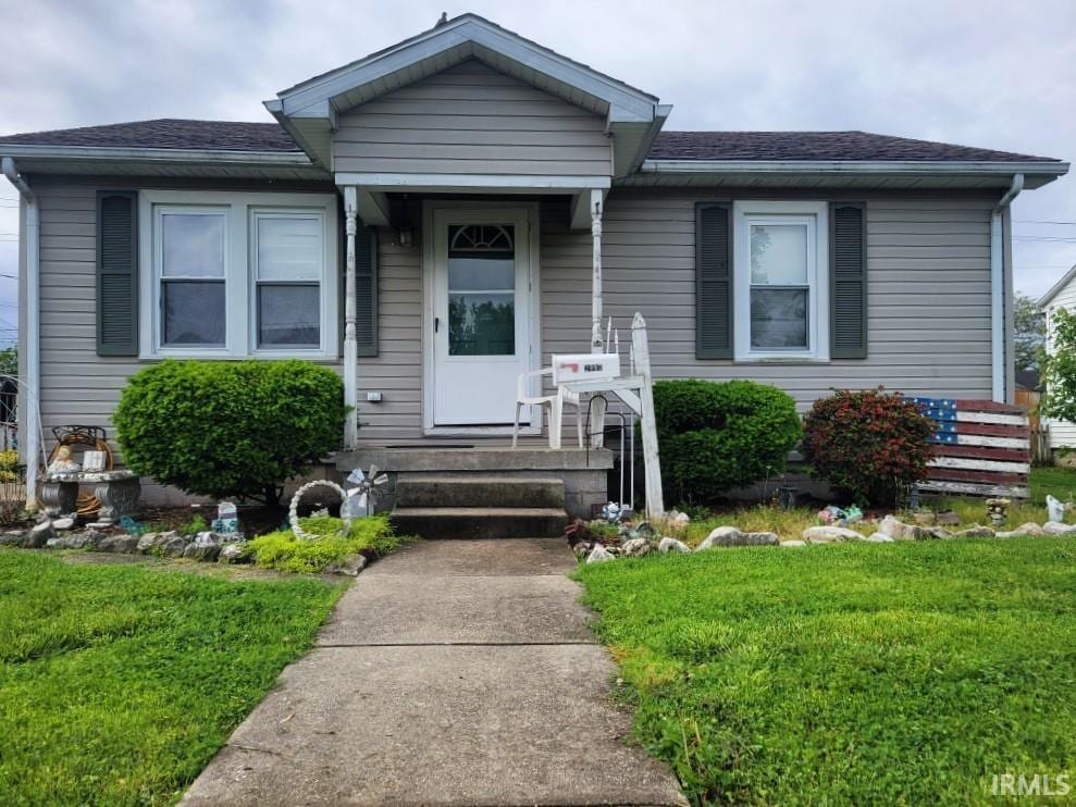 2007 Grand Ave, Washington, IN 47501 - view of front of property with a front yard and a shingled roof