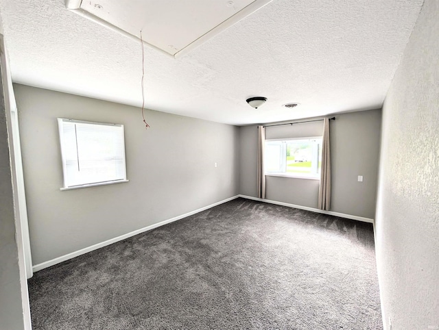 7382 Denise Dr, Fort Wayne, IN 46835 - empty room featuring attic access, a textured ceiling, carpet flooring, and baseboards