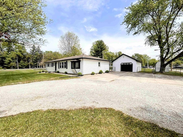 7382 Denise Dr, Fort Wayne, IN 46835 - view of front of house with concrete driveway, a detached garage, and an outdoor structure
