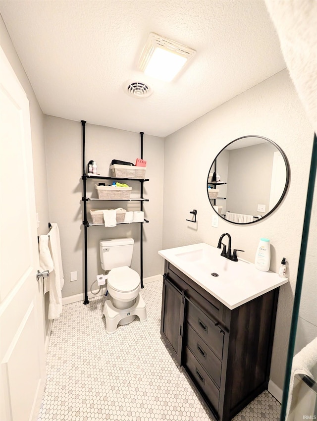 7382 Denise Dr, Fort Wayne, IN 46835 - bathroom featuring toilet, vanity, a textured ceiling, and baseboards