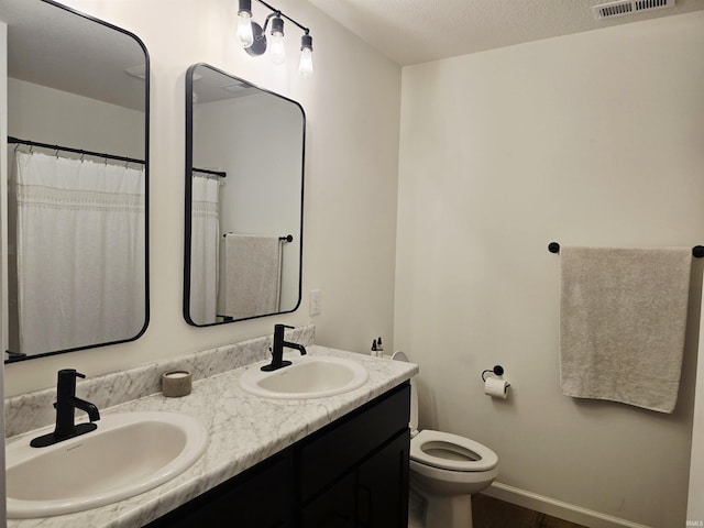1485 Radomiro Psge, Fort Wayne, IN 46845 - bathroom featuring double vanity, toilet, and baseboards
