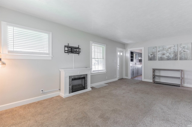 2500 N Govenor St, Evansville, IN 47711 - unfurnished living room featuring carpet flooring, baseboards, and a fireplace