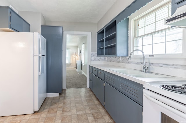 2500 N Govenor St, Evansville, IN 47711 - kitchen featuring white appliances, baseboards, blue cabinetry, and plenty of natural light