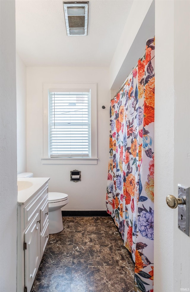 2500 N Govenor St, Evansville, IN 47711 - full bathroom featuring stone finish floors, vanity, toilet, baseboards, and a shower with shower curtain