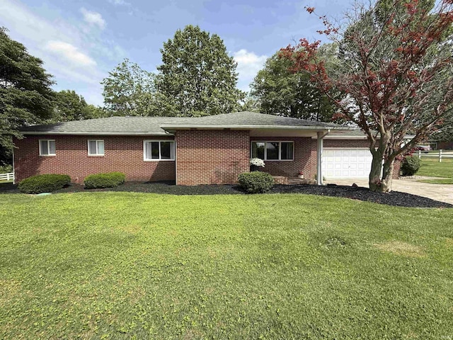 5522 N State Rd 57, Petersburg, IN 47567 - view of home's exterior with an attached garage, concrete driveway, a yard, and brick siding