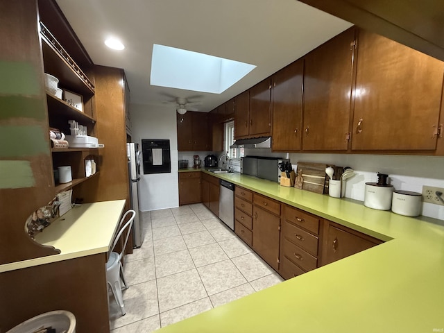 5522 N State Rd 57, Petersburg, IN 47567 - kitchen with a skylight, stainless steel appliances, light countertops, open shelves, and recessed lighting