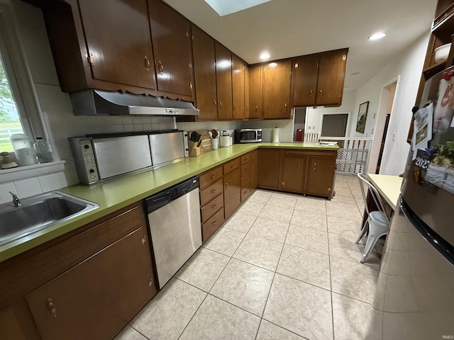 5522 N State Rd 57, Petersburg, IN 47567 - kitchen featuring stainless steel appliances, exhaust hood, a peninsula, light tile patterned flooring, and a sink
