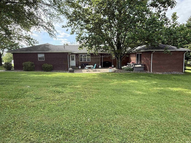 5522 N State Rd 57, Petersburg, IN 47567 - back of property with a patio, a lawn, and brick siding