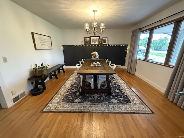 5522 N State Rd 57, Petersburg, IN 47567 - dining area featuring a chandelier, wood finished floors, and baseboards