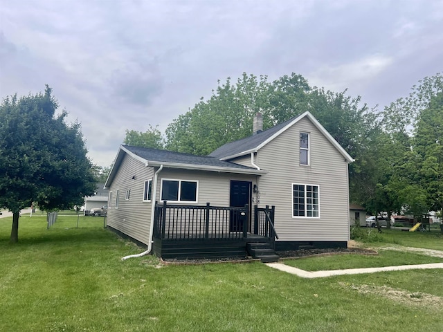 608 W Polywood Way, Syracuse, IN 46567 - view of front of house featuring a front yard, a wooden deck, a chimney, and a shingled roof