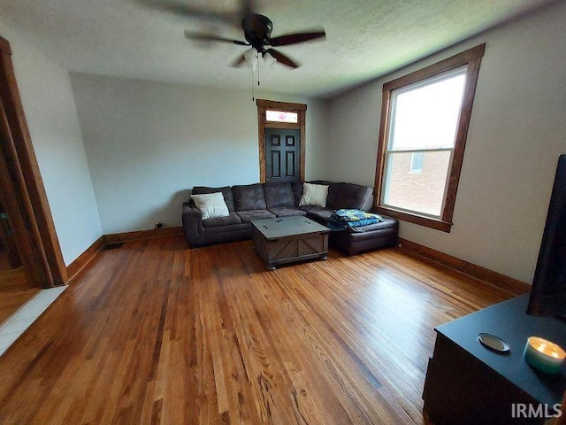 306 E 8th St, Jasper, IN 47546 - living area with wood finished floors, ceiling fan, and baseboards