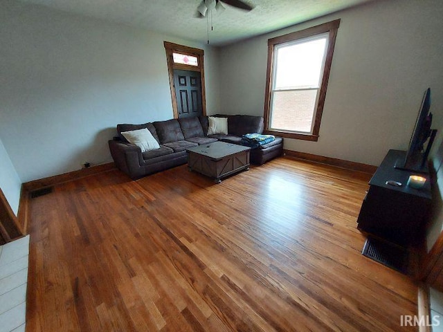 306 E 8th St, Jasper, IN 47546 - living room featuring light wood-style floors, a ceiling fan, and baseboards