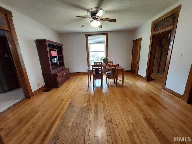 306 E 8th St, Jasper, IN 47546 - dining space with light wood finished floors, ceiling fan, and baseboards