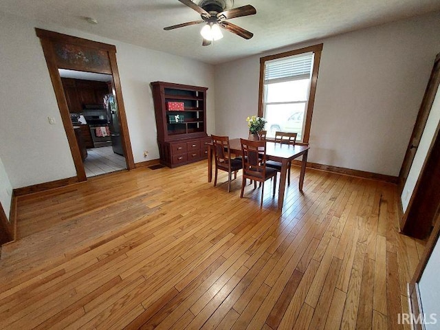 306 E 8th St, Jasper, IN 47546 - dining area featuring light wood-style flooring, a ceiling fan, and baseboards