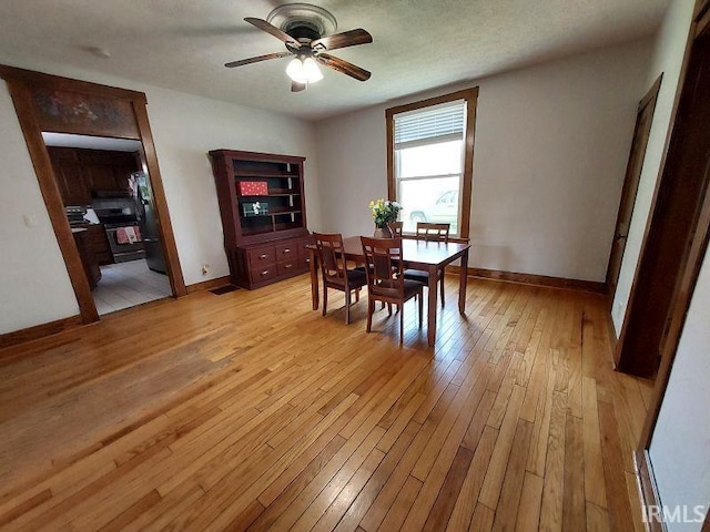 306 E 8th St, Jasper, IN 47546 - dining space with a ceiling fan, light wood-style floors, and baseboards