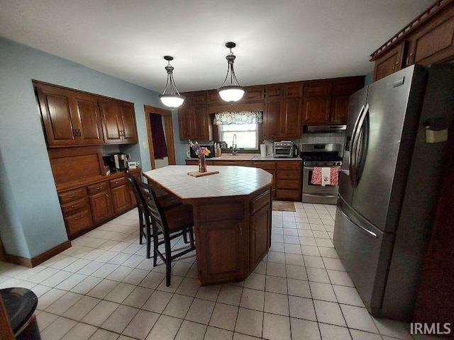 306 E 8th St, Jasper, IN 47546 - kitchen featuring stainless steel appliances, tile counters, light tile patterned flooring, under cabinet range hood, and decorative backsplash