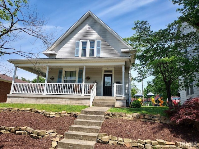 306 E 8th St, Jasper, IN 47546 - view of front of home with a playground and covered porch