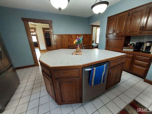 306 E 8th St, Jasper, IN 47546 - kitchen with tile counters, light tile patterned flooring, stainless steel dishwasher, and a center island
