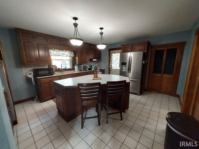 306 E 8th St, Jasper, IN 47546 - kitchen featuring stainless steel fridge with ice dispenser, a sink, tile countertops, a center island, and light tile patterned floors