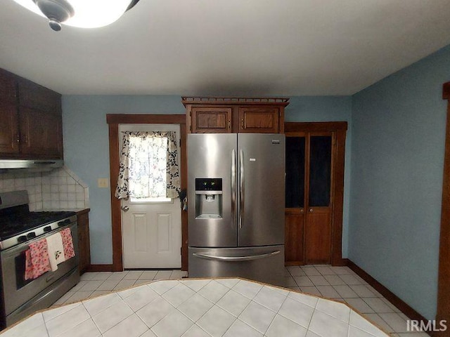 306 E 8th St, Jasper, IN 47546 - kitchen featuring appliances with stainless steel finishes, light tile patterned floors, ventilation hood, and backsplash
