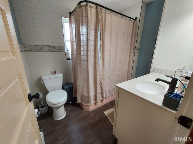 306 E 8th St, Jasper, IN 47546 - full bathroom featuring toilet, wood finished floors, vanity, curtained shower, and tile walls