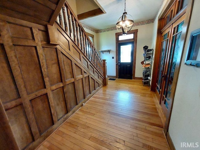 306 E 8th St, Jasper, IN 47546 - foyer with light wood-style flooring, stairway, and baseboards