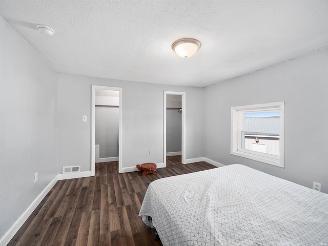 3780 S 550 E, Hamilton, IN 46742 - bedroom featuring wood finished floors, baseboards, a spacious closet, a textured ceiling, and a closet