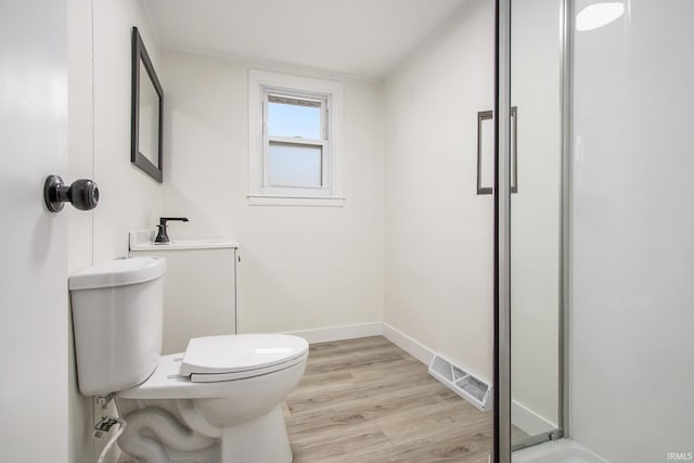 718 W 8th St, Mishawaka, IN 46544 - full bathroom featuring toilet, wood finished floors, a shower, and baseboards