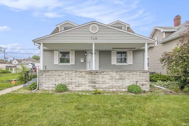 718 W 8th St, Mishawaka, IN 46544 - view of front facade featuring a front lawn, a porch, and stone siding