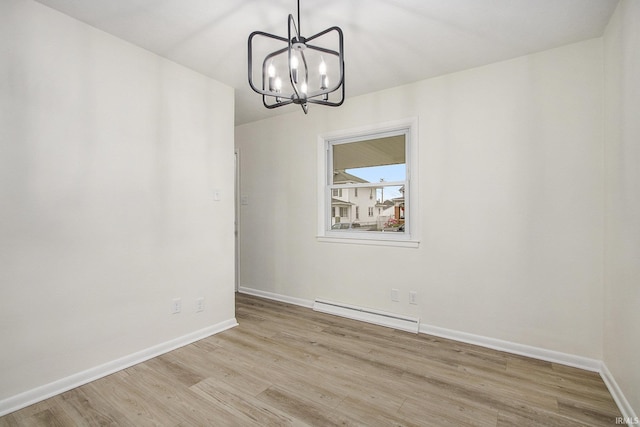 718 W 8th St, Mishawaka, IN 46544 - spare room featuring a baseboard radiator, wood finished floors, baseboards, and a chandelier