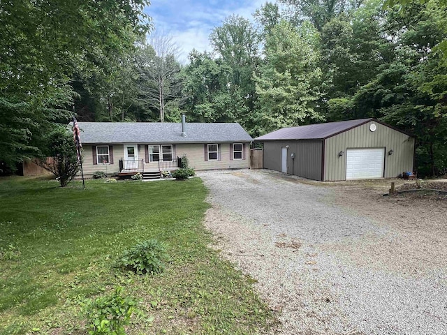 2940 N Stanford Woods Dr, Solsberry, IN 47459 - ranch-style home featuring gravel driveway, a detached garage, an outdoor structure, a front yard, and a wooden deck