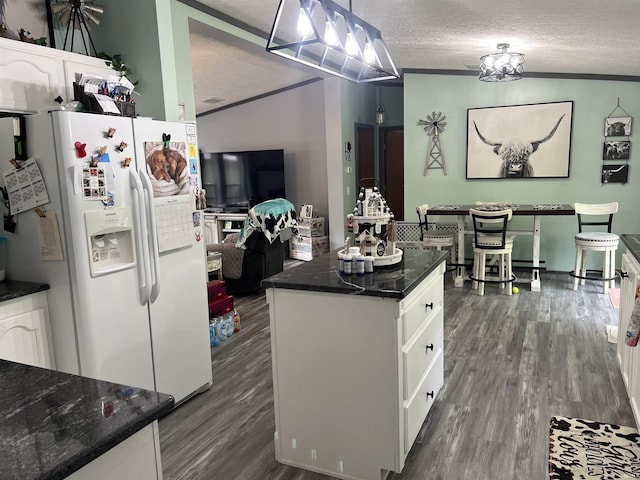 2940 N Stanford Woods Dr, Solsberry, IN 47459 - kitchen with white fridge with ice dispenser, dark wood-style flooring, white cabinets, a textured ceiling, and a kitchen island