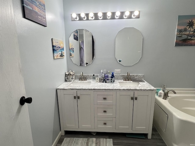 2940 N Stanford Woods Dr, Solsberry, IN 47459 - bathroom featuring double vanity, wood finished floors, and a bath
