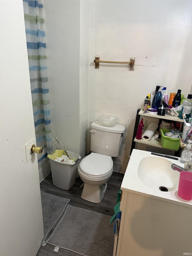 1214 Spear St, Logansport, IN 46947 - bathroom featuring vanity, toilet, and wood finished floors