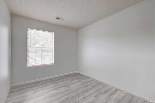3220 E John Hinkle Pl Unit F, Bloomington, IN 47408 - empty room with light wood finished floors, a textured ceiling, and baseboards