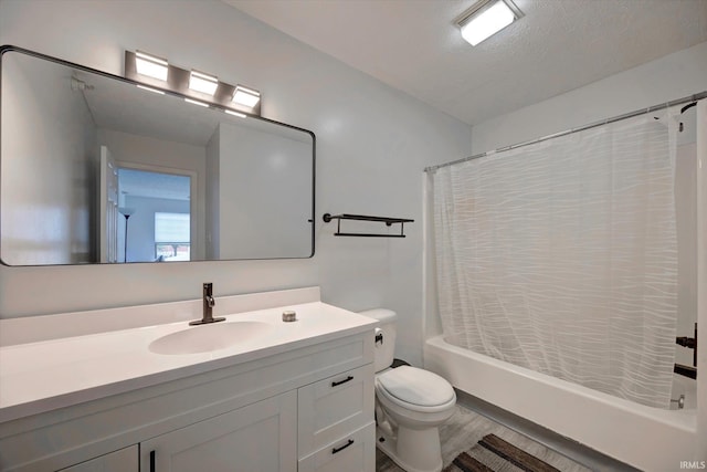 3220 E John Hinkle Pl Unit F, Bloomington, IN 47408 - bathroom with shower / tub combo with curtain, toilet, vanity, wood finished floors, and a textured ceiling