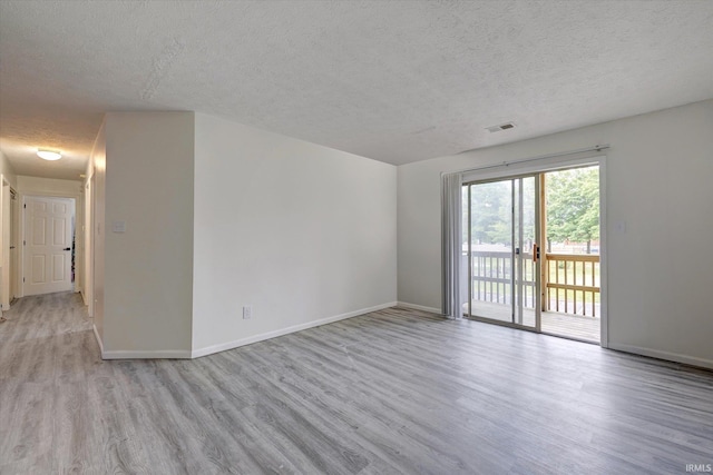 3220 E John Hinkle Pl Unit F, Bloomington, IN 47408 - unfurnished room with a textured ceiling, wood finished floors, and baseboards