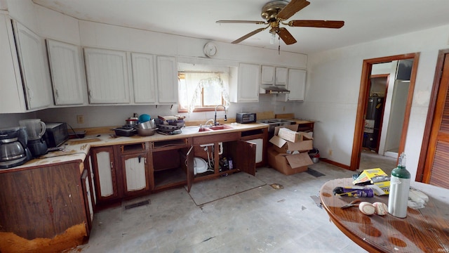 736 N 13th St, Elwood, IN 46036 - kitchen featuring water heater, under cabinet range hood, a ceiling fan, white cabinets, and light countertops