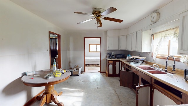 736 N 13th St, Elwood, IN 46036 - kitchen with plenty of natural light, unfinished concrete flooring, a ceiling fan, and light countertops