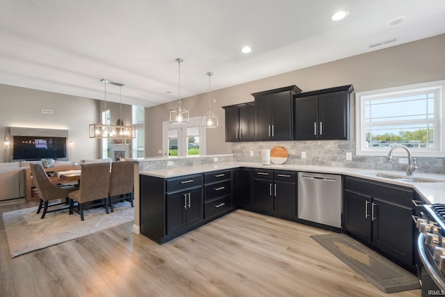 13909 Stone Table Blvd, Fort Wayne, IN 46845 - kitchen featuring appliances with stainless steel finishes, open floor plan, a sink, decorative backsplash, and recessed lighting