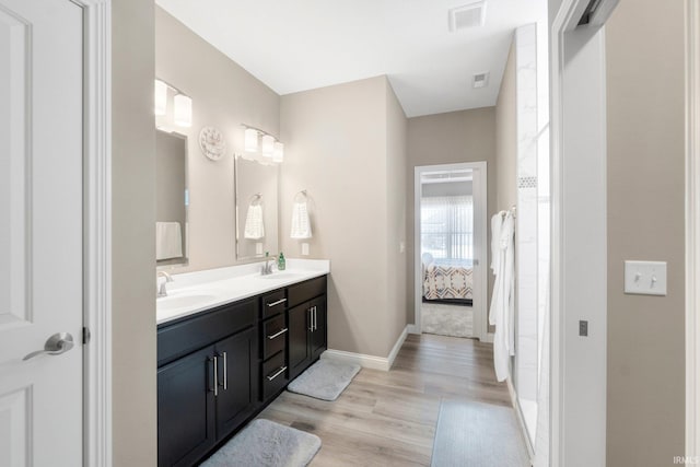 13909 Stone Table Blvd, Fort Wayne, IN 46845 - full bathroom featuring double vanity, wood finished floors, baseboards, and connected bathroom