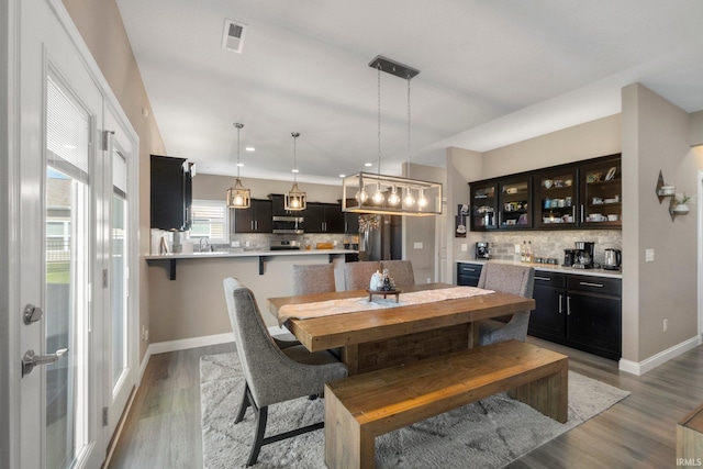 13909 Stone Table Blvd, Fort Wayne, IN 46845 - dining room with bar, baseboards, light wood-style flooring, and recessed lighting