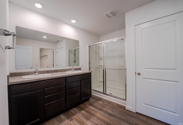 1208 Mount Isa Pl, Fort Wayne, IN 46845 - bathroom with a stall shower, double vanity, wood finished floors, a spacious closet, and recessed lighting