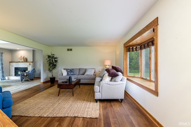 7819 Greenwell Rd, Churubusco, IN 46723 - living room featuring wood finished floors, a fireplace, and baseboards