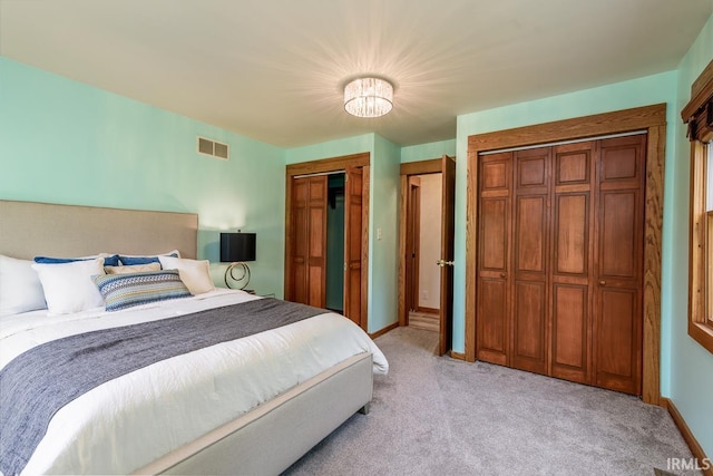 7819 Greenwell Rd, Churubusco, IN 46723 - bedroom with light colored carpet, two closets, and baseboards